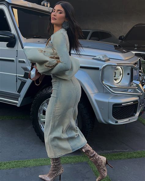 Kylie Jenner spills out of denim dress as she poses in .5K 